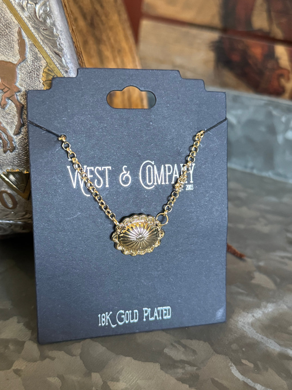 Gold concho necklace on a West & Company branded card with '18K Gold Plated' text.