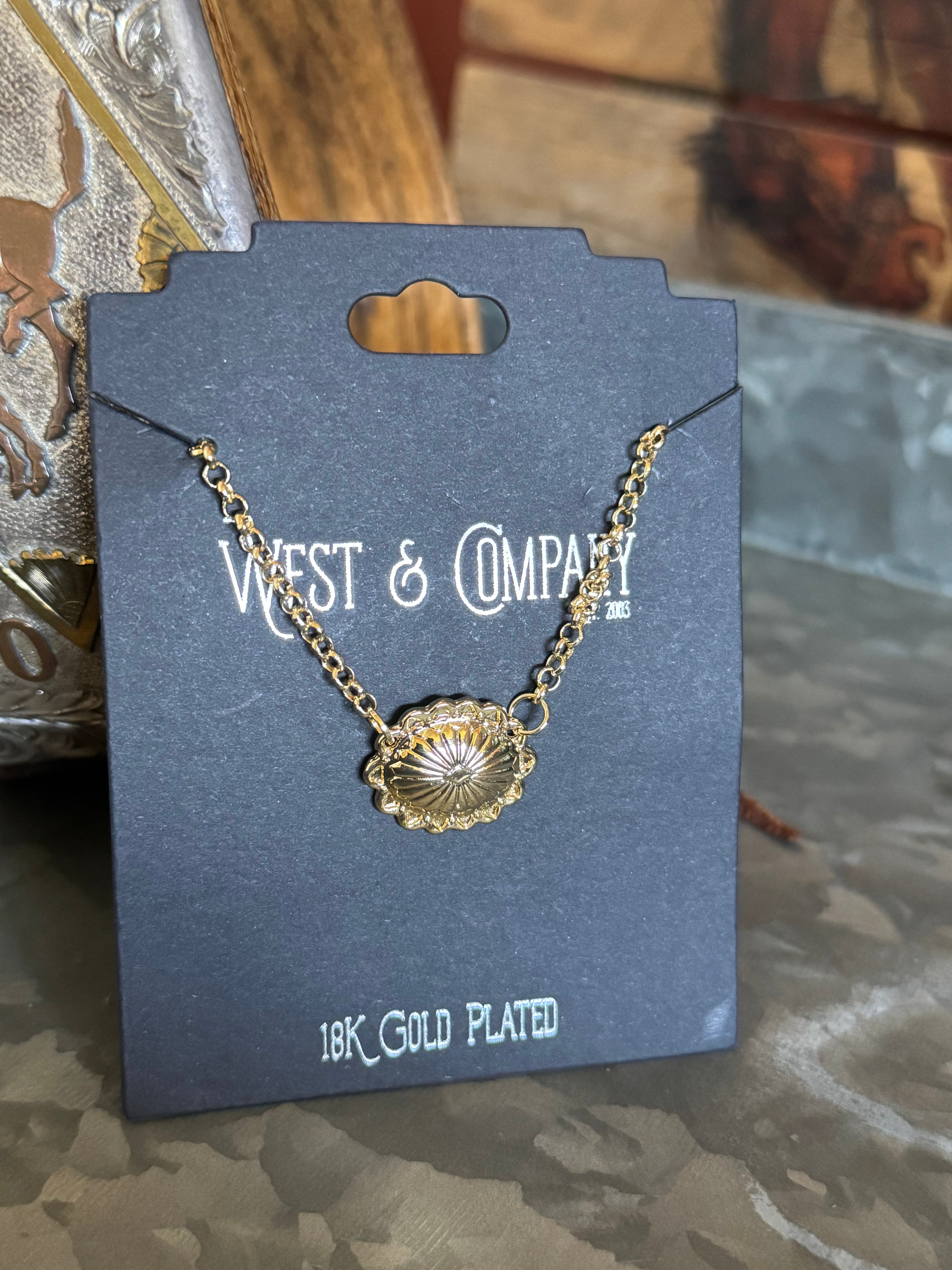 Gold concho necklace on a West & Company branded card with '18K Gold Plated' text.