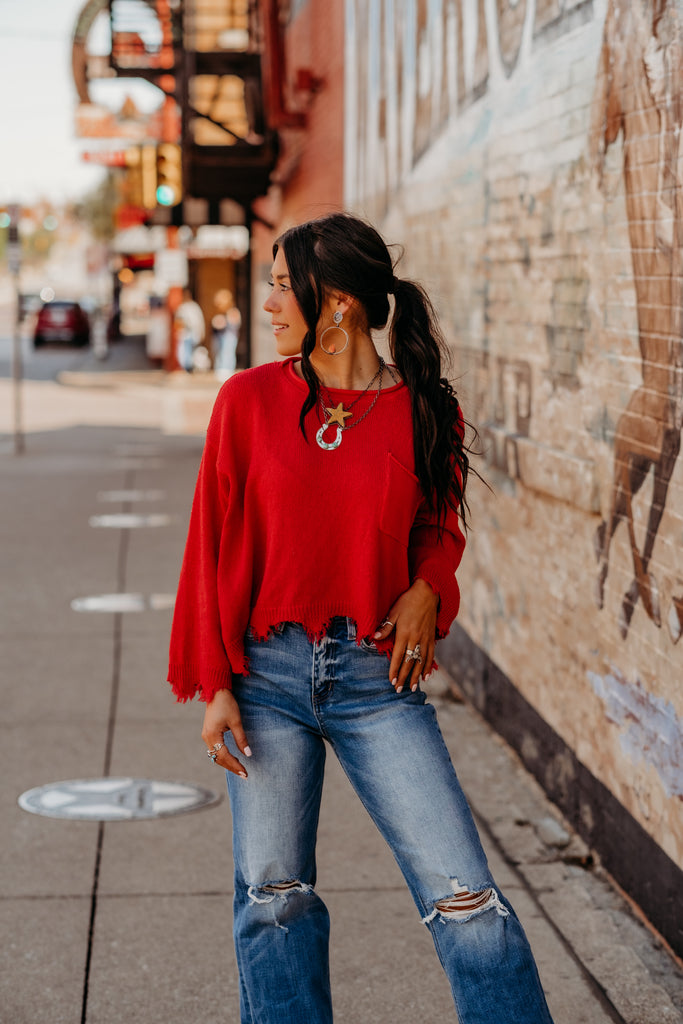 red distressed sweater